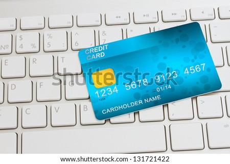 blue  plastic card  on modern keyboard - internet shopping concept