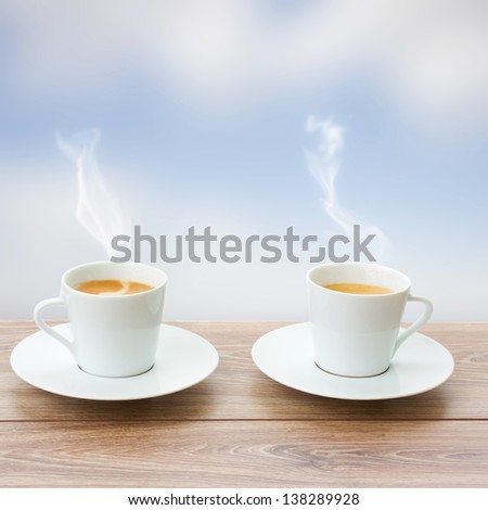 two cup of coffee on wooden table and  blue sky background