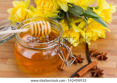 floral honey pot with spises  on wooden table