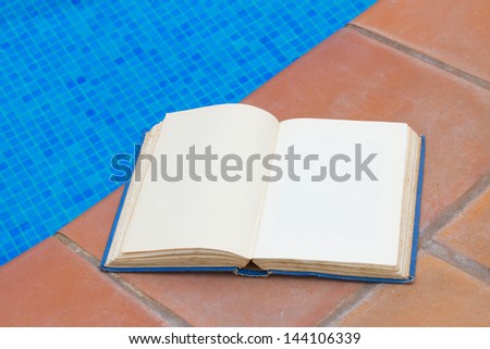 summer reading open book at pool side