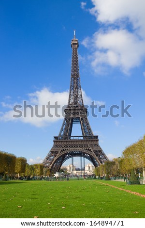 Eiffel Tower with green lawn in sunny day in Paris France Eiffel Tower with green lawn in sunny day in Paris France