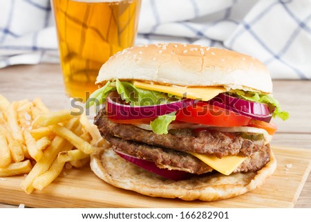 Big fresh  burger with french fries and beer