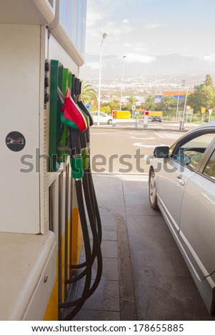 row of petrol station pupmps and car close up