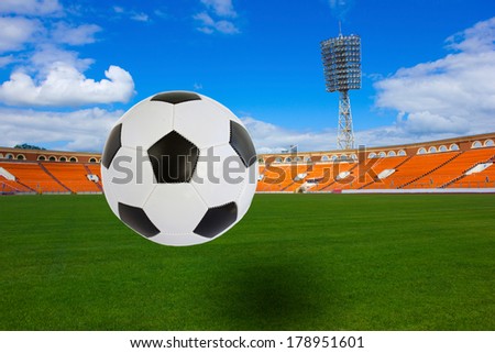 black and white soccer ball flying over football field on football stadium