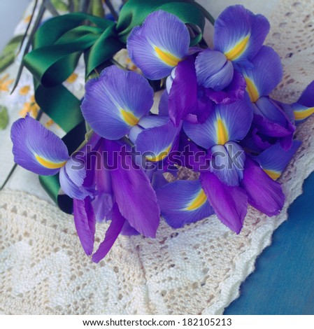 bouquet of iris flowers laying on blue  table