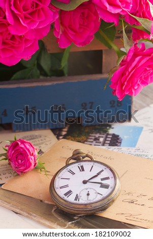 old times  concept  pile of old letters  with flowers and  antique  clock