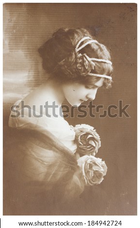 POLAND, WARSAW - CIRCA 1913: old photo portrait of young woman with flowers. Illustrative Image, subject of human interest