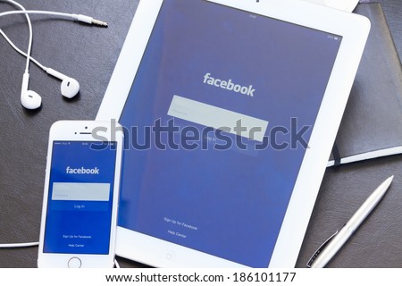 WARSZAWA, POLAND - APRIL 01, 2014: Facebook app on screen of Ipad and Iphone 5s. Facebook is the largest social network in the world. It was founded in 2004 by Mark Zuckerberg and his roommates.