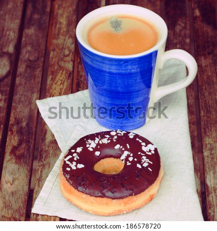 donut with coffee mug served on wooden table