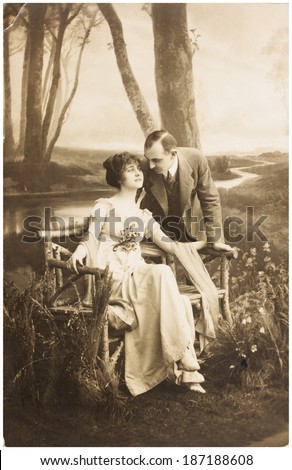 POLAND, WARSAW - CIRCA 1924 : old photo  of young romantic couple of woman and man in spring garden. Illustrative Image, subject of human interest