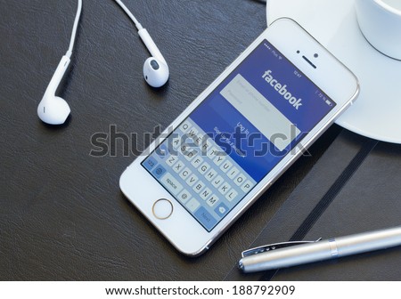 WARSZAWA, POLAND - APRIL 01, 2014: Loging in Facebook app on Iphone5s Facebook is the largest social network in the world. It was founded in 2004 by Mark Zuckerberg .