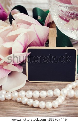 weding greetings  - magnolia flowers and pearls with copy space on black chalk board