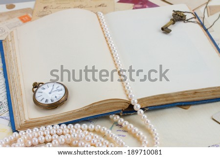 empty old open book  with  strand of pearls vintage background with copy space