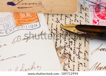 old golden quill pen and antique letters