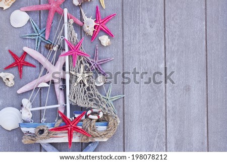Marine life with seashells,  starfish and boat , copy space on wooden planks