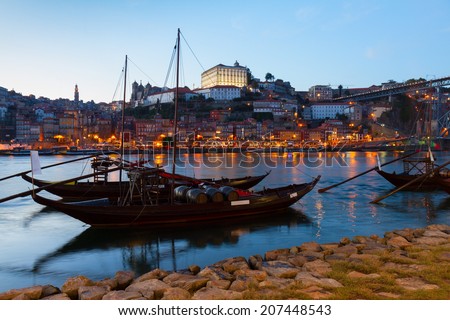 Night scene of Porto with  Douro river and traditional port wine boats, Portugal