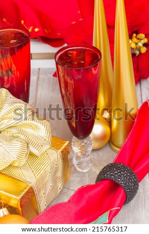red glasse with christmas champagne and golden decorations