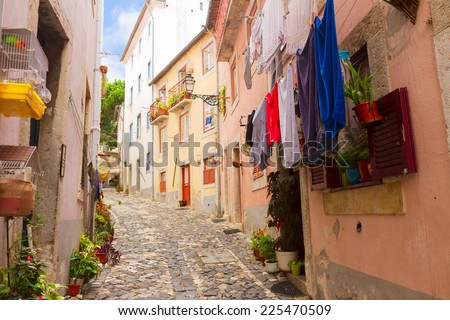 street with colorful drying clothes  in old town of Lisbon, Portugal