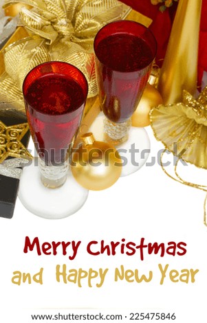 two red glasses with christmas champagne  with golden decorations isolated on white background