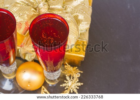 red glasses with  champagne wine  and golden decorations on black table