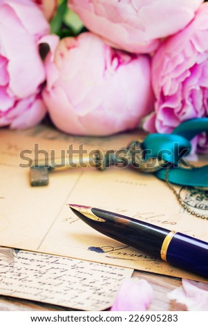 vintage golden quill pen and antique letters with peonies flowers and key