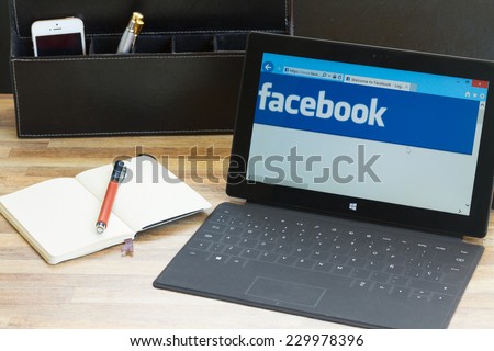 WARSZAWA, POLAND - OCTOBER 10, 2014: Facebook page on screen of Windows tablet Surface. Facebook the largest social network in the world.