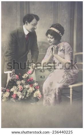 POLAND, WARSAW - CIRCA 1900s : old photo  of  young romantic couple of woman and man in spring garden.