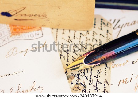 old retro golden quill pen and antique letters