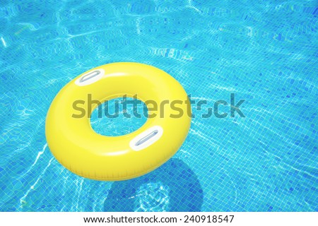 rubber ring floating in transparent blue tiled pool, retro toned