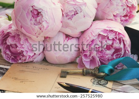 vintage quill pen and antique letters with peonies flowers and key, retro toned