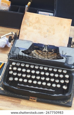 black vintage typewriter with empty aged  page