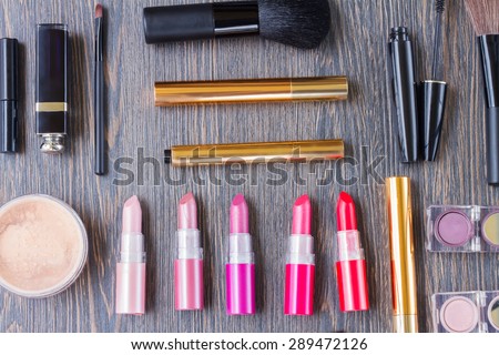 set of  brushes, lipsticks, maskara and  eye shadows, top view