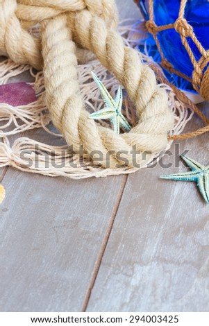 marine rope with fishing net on wooden background with copy space