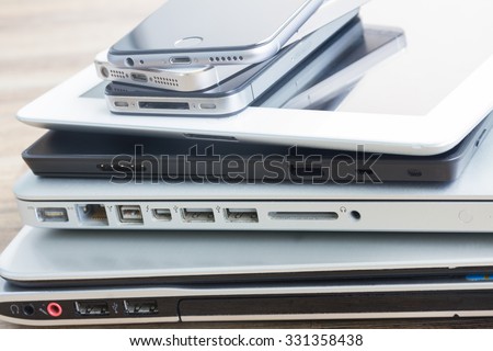 heap  of modern glossy electronical devices  - technology concept