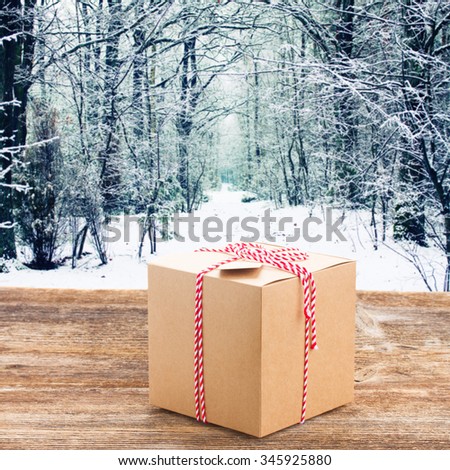 Handmade paper gift box on wooden table border isolated on white background