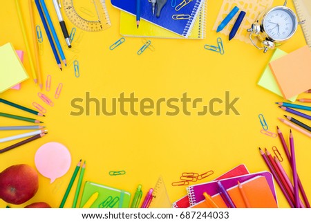 back to school or office styled  scene with multicolored school supplies on yellow , back to school conceptual background