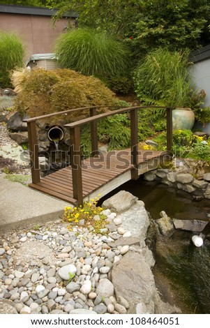 A bridge spans the water drainage on a property