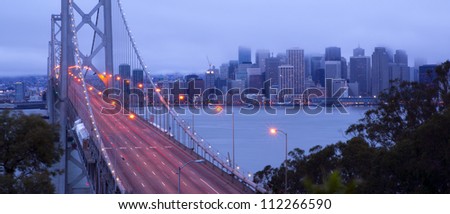 Traffic moves into downtown San Francisco early in the morning across the Bay Bridge