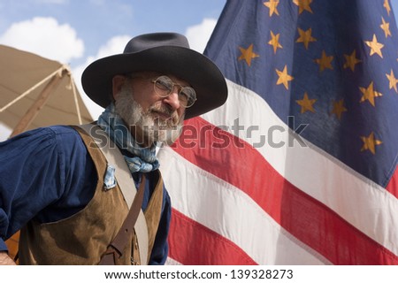 STEILACOOM, WASHINGTON/USA -  MAY 1: A scout for the Army Civil War Re-enactors stands by flag in camp at re-enactment in the Pacific Northwest May 1, 2010.