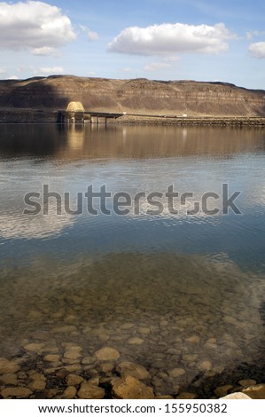 Smooth water reflects blue sky producing a beautiful reflection in the Columbia River Valley Eastern Washington