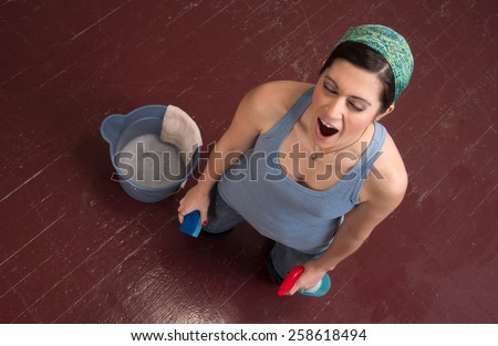 Tired Blue Collar Worker Maid Doing Cleaning Chores Scrubbing Floor