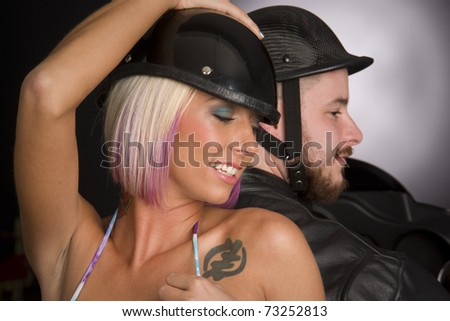 Profile of a Biker Couple Wearing Helmets Riding Motorcycle Man Woman