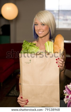Smiling Blond Woman Holding Brown Bag of Groceries Food Shopping Celery Bread