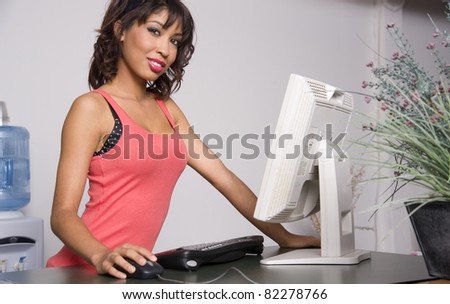 Pretty woman on the computer browsing the internet hand on mouse