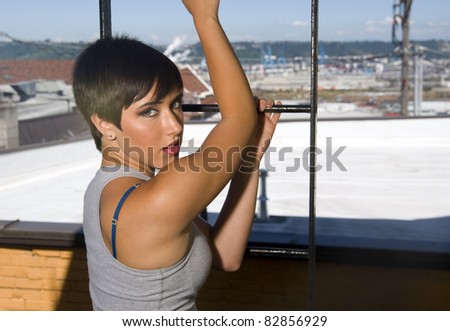 Young Woman out on Urban Downtown Fire Escape