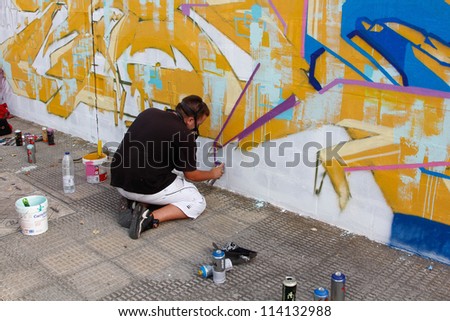 MADRID, SPAIN-SEPT. 18 : Unidentified man draws on the wall with a can of spray during first International Graffiti and Dance on September 18, 2012 in Madrid, Spain.