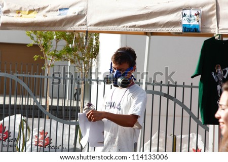 MADRID, SPAIN-SEPT. 18:Unidentified man draws on the wall with a can of spray during first International Graffiti and Dance on September 18, 2012 in Madrid, Spain.
