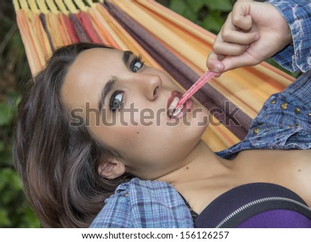 Pretty face very sensual woman lying in a hammock