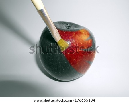 an apple red paint with a brush
