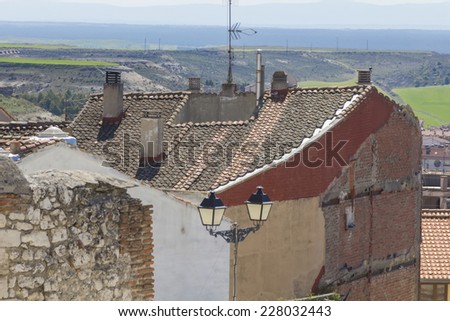 roofs and chimneys with iron lamppost